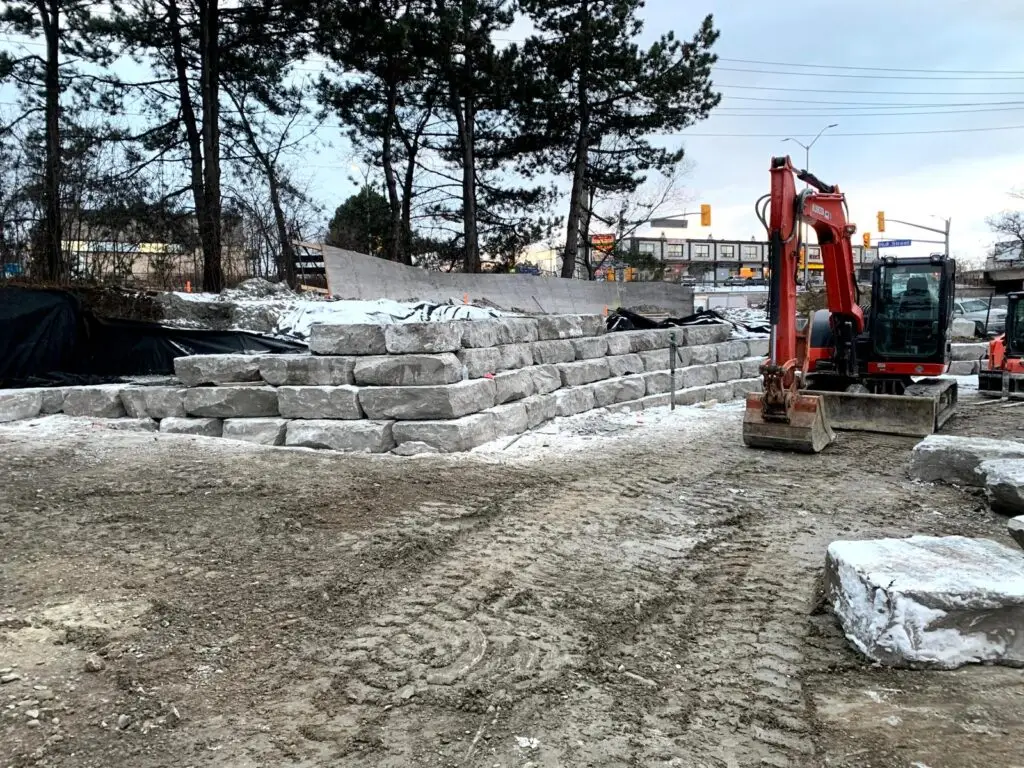 Armour stone wall under construction by Scott & Sons Landscape Construction