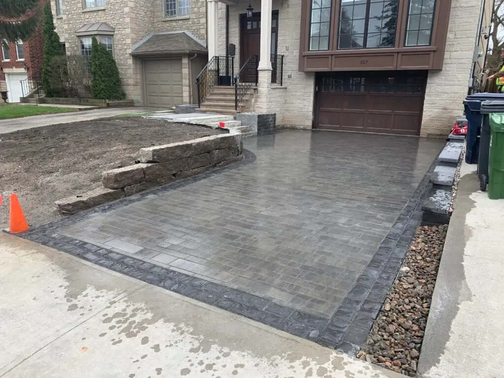 Interlock driveway and armour stone wall by Scott & Sons Landscape Construction