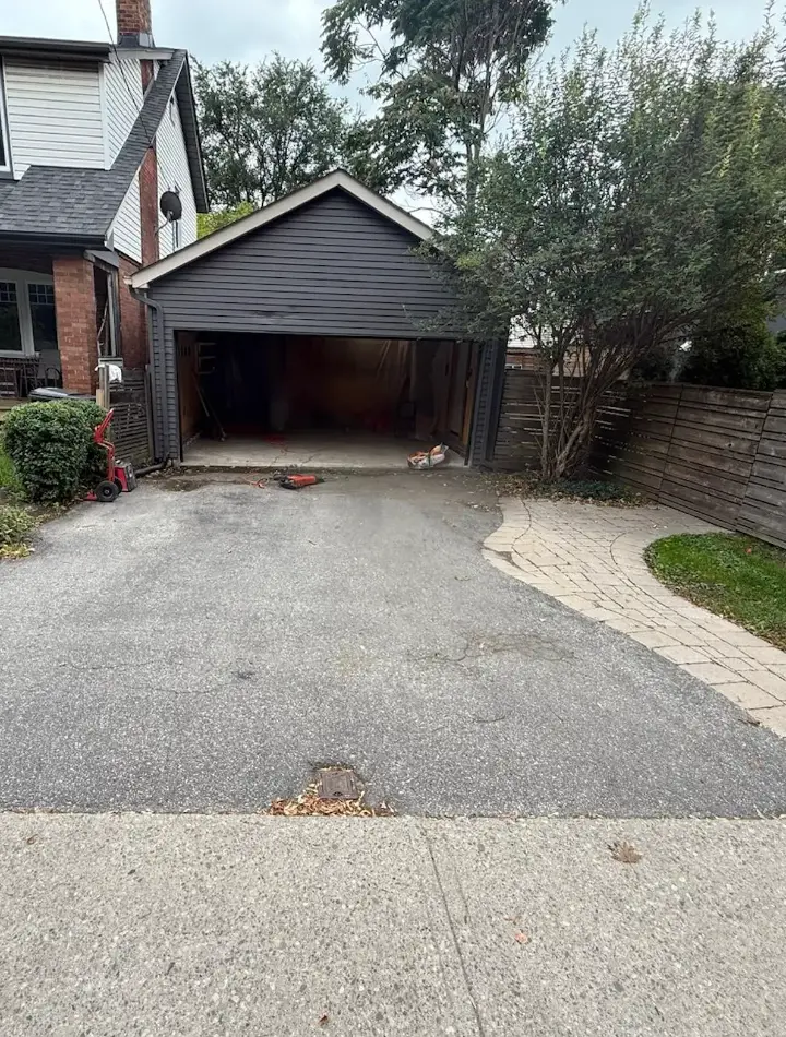 Before: asphalt driveway at detached garage